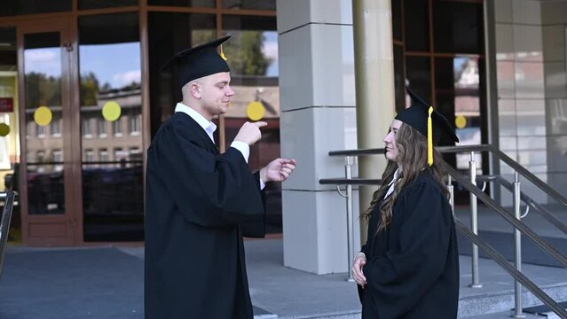 Hard of hearing graduates communicate in sign language. 