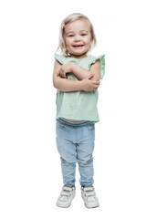 Laughing little girl in jeans and a green blouse. Positive and happy childhood. Isolated on white background. Vertical.