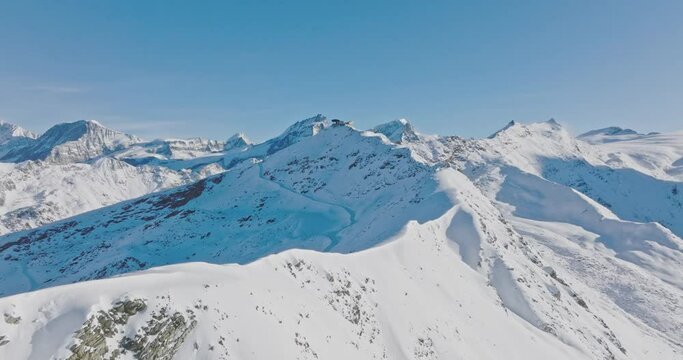 Aerial drone flyover Gornergrat with Matterhorn view during winter in Switzerland. Majestic mountain peaks iconic famous zermatt travel ski resort in the alps. Wonderful inspiring nature landscape.