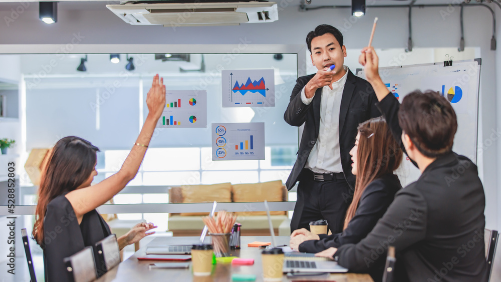 Wall mural asian handsome professional successful businessman presenter standing holding pen pointing presentin