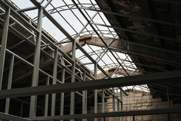 Concrete hangar with iron roof structure, indoors. Industrial building