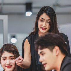 Asian young beautiful professional successful businesswoman mentor standing smiling pointing...