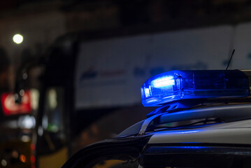 Emergency light of police patrolling car on street in night