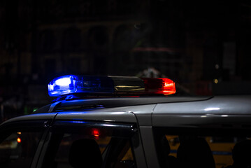 Emergency light of police patrolling car on street in night © suman