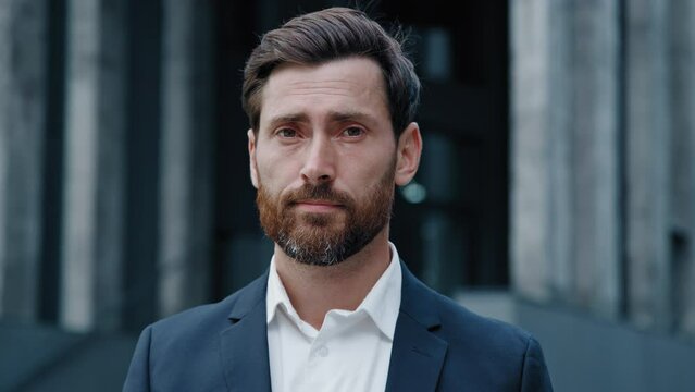 Male business portrait embarrassed dissatisfied man leader looking at camera replies negative answer frustrated businessman demonstrates refusal expresses prohibition disapproval responds to question