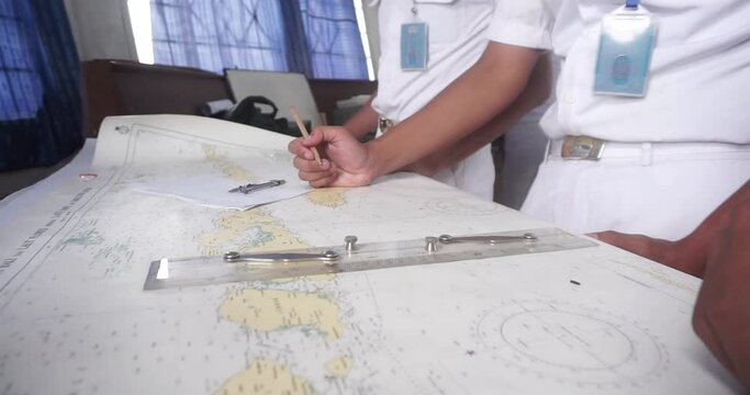 Students are studying and measuring Distance On A Map With A School Compass. Close-Up