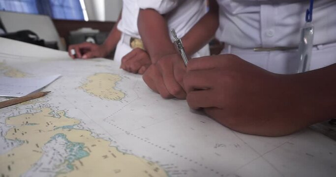 Student study Navigation ship chart for building a sailing route. Maps of the ship for plotting. Plotter, divider, ruler and pen. Nautical education.