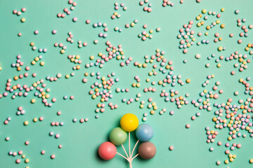 Colorful round balls over the mint background.