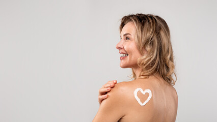 Beautiful Middle Aged Lady With Heart Made Of Body Cream On Shoulder