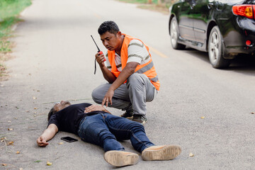 man accident lay down unconscious on the road hit by car during playing phone emergency team staff...
