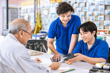 business shop male reception cashier staff care help support senior customer good service happy smile