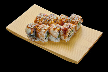 delicious Canada rolls on a wooden stand on a black isolated background