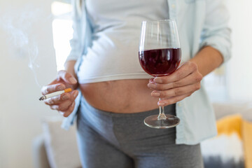 Smoking and alcohol pregnancy.woman on a long pregnancy drinking alcohol and Smoking...
