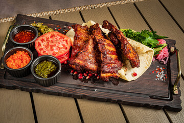 grilled ribs with flatbread and sauces