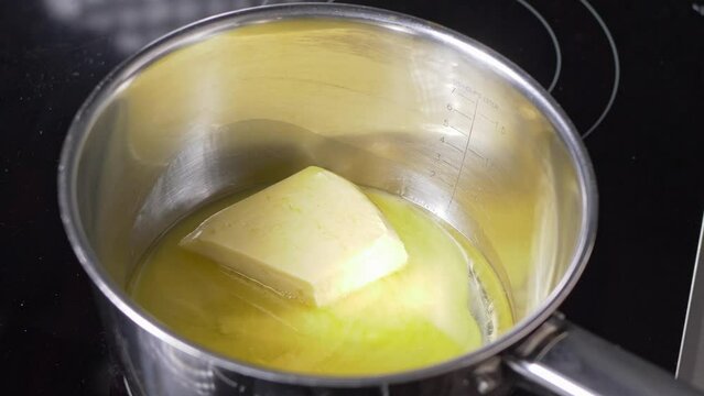Timelapse of butter melting in a pot. 