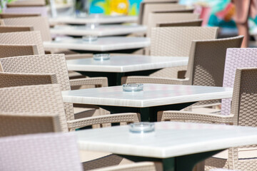 Tables and chairs in an open-air cafe.