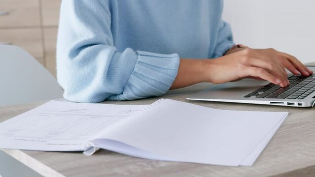 Laptop, paperwork and typing businesswoman in administration or human resources with invoice, payroll or company account data management. Busy, productive hands working on corporate finance report