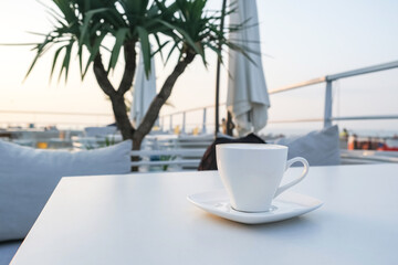 cup of coffee on a table in a cafe at dawn.Morning relaxation,meditation.Slow life.Coffee day