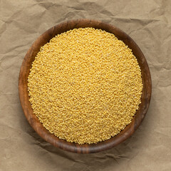 A bowl of millet groats. Top view, close-up.