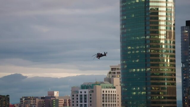 ARH Air Force Helicopter Flying Over Brisbane CBD Buildings At Sunset, 4K Slow Motion