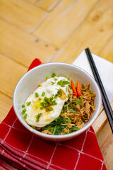 Fried noodles with fried egg and red chili