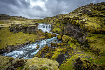 Fototapeta na wymiar waterfall, river and country volcanic landscape with rocks, Iceland