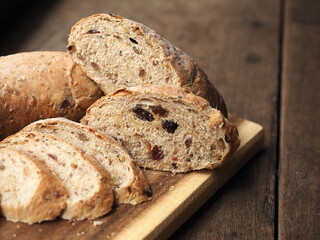 slice of whole wheat cereal and raisin bread on wooden board
