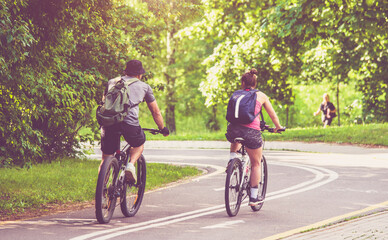 Fototapeta premium Cyclists ride on the bike path in the city Park 