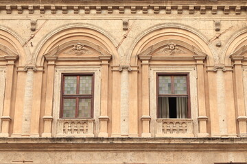 Fototapeta na wymiar Basilica of the Twelve Holy Apostles Facade Detail with Windows in Rome, Italy