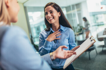 Two businesswomen talking in the office
