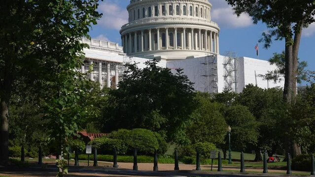 Close up view of the US Capitol building exterior. Tilt up shot revealing rotunda and Statue of Freedom.