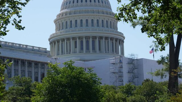 United States Capitol building close up. Tilt up from ground level. Front face of Capitol under renovation.