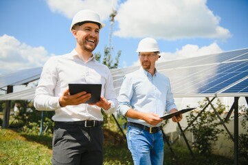 engineer and businessman planing new ecology project. around solar panel