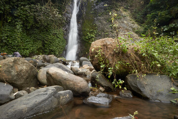 Naklejka na ściany i meble photo of a hidden waterfall, which is in Indonesia, a waterfall with a small water discharge