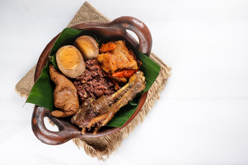 Gudeg Komplit. A Signature and Legendary Dish from Yogyakarta Indonesia. Jack Fruit Stew Accompanied with Spicy Stew of Cattle Skin Crackers and Brown Eggs, Tofu and Chicken.