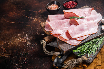 Flat slices of square sandwich ham with herbs. Dark background. Top view. Copy space