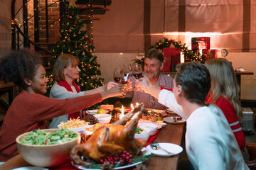 Family toasting on video call with near and dear ones on occasion of Christmas celebration