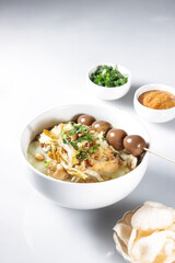 Bubur Ayam or Indonesian Rice Porridge with Shredded Chicken, cheese stick and cakwe.