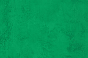 Fototapeta na wymiar Saturated pastel bright green colored low contrast Concrete textured background. Empty colourful wall texture with copy space for text overlay and mockups. 2023, 2024 color trend