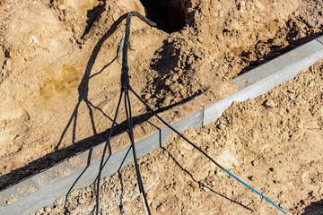The high voltage electrical cable is laid in a trench under existing engineering sewerage networks....
