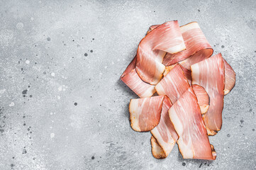 Black Forest Ham Slices on kitchen table. Gray background. Top view. Copy space