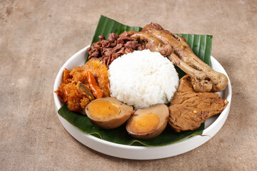 Nasi Gudeg. A Signature and Legendary Dish from Yogyakarta Indonesia. Jack Fruit Stew Accompanied with Spicy Stew of Cattle Skin Crackers and Brown Eggs, Tofu and Chicken.