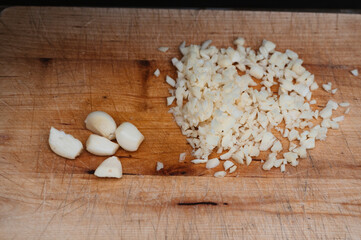 Detail to wooden table with pieces of garlic