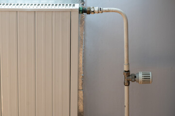 Detail of thermostat and regulator in old house radiator. Increasing prices of energies and heat