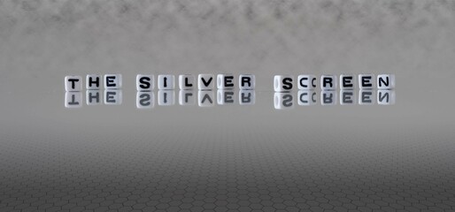 the silver screen word or concept represented by black and white letter cubes on a grey horizon...