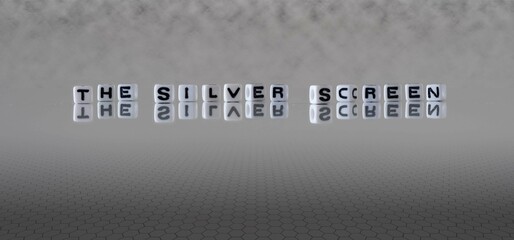 the silver screen word or concept represented by black and white letter cubes on a grey horizon background stretching to infinity
