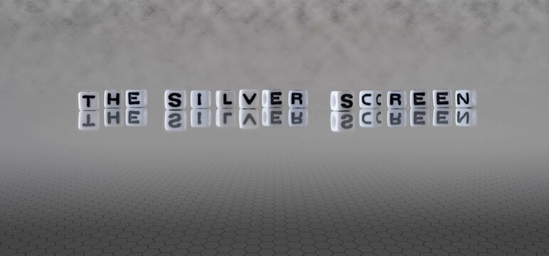 the silver screen word or concept represented by black and white letter cubes on a grey horizon background stretching to infinity