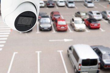 Technician installed IP CCTV camera hi-technology for look security area of work in car parking lot show signage with security cars park in area
