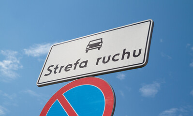 D-52 Traffic zone sign in Poland. Entering an internal road located in the traffic zone. With B-35 No parking sign below. Letters in Polish language, Strefa Ruchu means Traffic Zone. - obrazy, fototapety, plakaty
