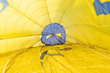 Inside view of hot air balloon main Envelope. Colourful heat-resistant fabric with parachute valve...
